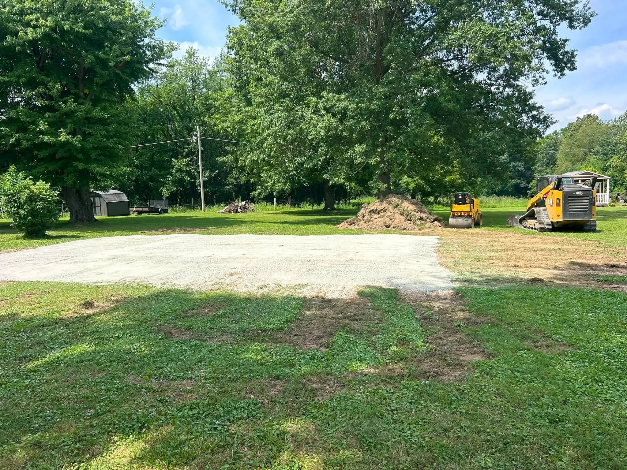 Heavy machinery performing professional land clearing and vegetation removal on a residential lot in Connersville Indiana